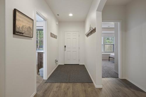 a hallway with white walls and a white door at Four Seasons Retreat in Bend