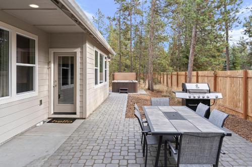 a patio with a grill and a table and chairs at Four Seasons Retreat in Bend