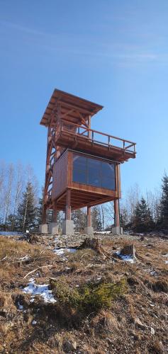 a wooden structure sitting on top of a field at AlVa- relax a oddych v Slovenskom raji in Dedinky