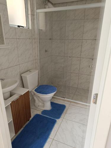 a bathroom with a toilet and a sink and a shower at Apartamento Umuharama in Pelotas