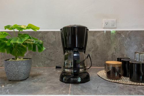 a black blender sitting on a counter next to a plant at Tierra Buena Countryside Hotel in Monteverde Costa Rica