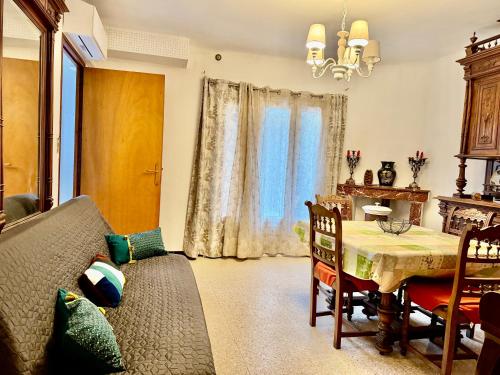un salon avec une table et un canapé dans l'établissement Appartement F3 de 60 m² au rez de chaussée d'une villa, à Vézénobres