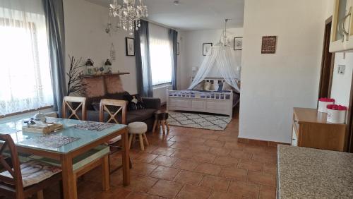 a living room with a table and a baby crib at Penzion Villa Verde Moravia in Klentnice