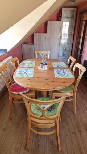a wooden table with chairs and a dining room at Penzion Villa Verde Moravia in Klentnice