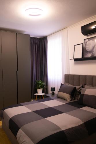a bedroom with a large bed and a window at Radeshi House in Berat