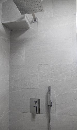 a bathroom with a shower with aperature at Radeshi House in Berat