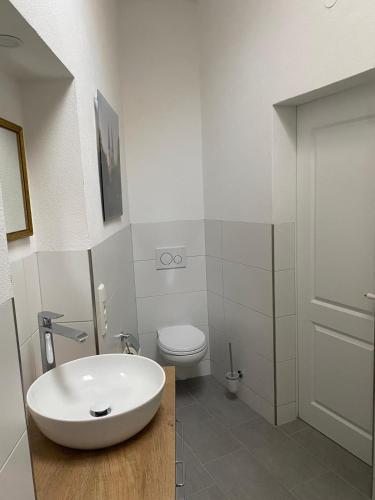 a bathroom with a white sink and a toilet at Kleiner Marstall in Xanten