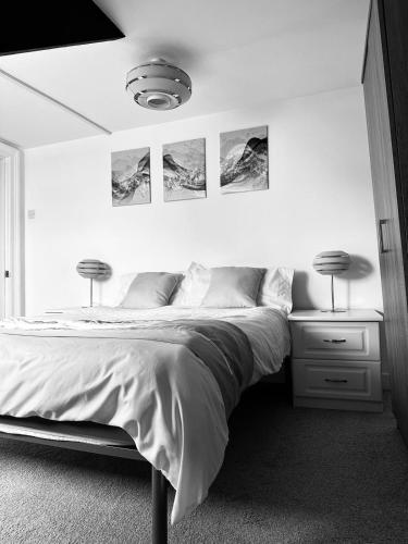 a bedroom with a bed with two lamps on it at Private Parking, Urban Comfort & City Haven in Plymouth