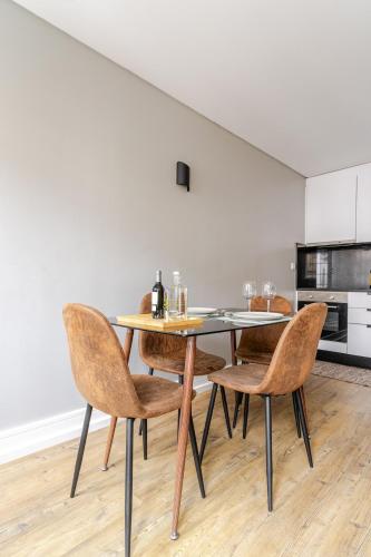 a dining room with a table and chairs at Ardósia in Vila Real