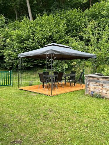 a gazebo with a table and chairs under it at Das idyllische Zweithaus! in Scheiblingkirchen
