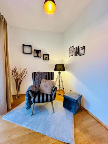 a living room with a chair and a lamp at Das idyllische Zweithaus! in Scheiblingkirchen