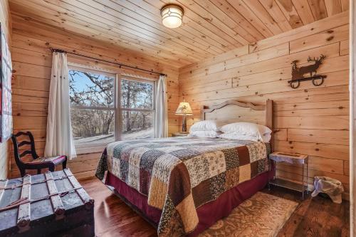 a bedroom with a bed in a log cabin at Straight From The Heart in Lyle