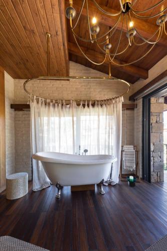 a large bathroom with a tub and a window at Casa Mila Kazdağları in Büyükçetmi