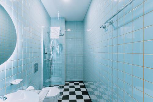 a bathroom with a shower and a toilet and a sink at Hotel Twenties Tbilisi - Stay & Dine in Tbilisi City