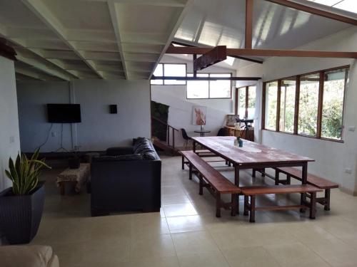 a living room with a wooden table and a couch at Volcano Panoramic Views in Vara Blanca