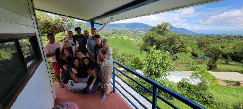 a group of people posing for a picture on a balcony at Volcano Panoramic Views in Vara Blanca
