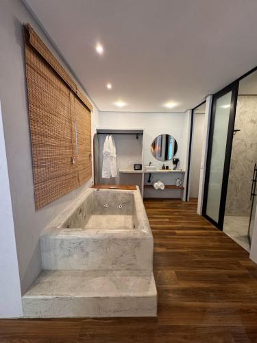 a bathroom with a large tub in a room at Casas Oba in Morro de São Paulo