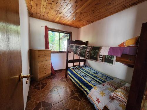 a bedroom with two bunk beds and a window at House, airport side in Pucón