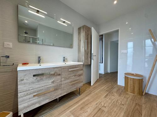 une salle de bain avec un lavabo et un miroir dans l'établissement Maison Neuve 5 Personnes - Proche de la Mer - EXT, à La Tranche-sur-Mer