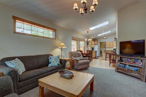 a living room with a couch and a table at Huckleberry Cottage in Bend