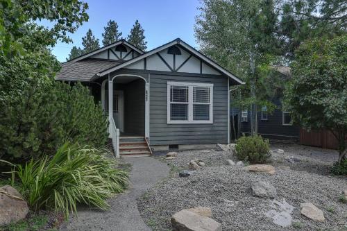 a small house with a porch and a yard at Huckleberry Cottage in Bend