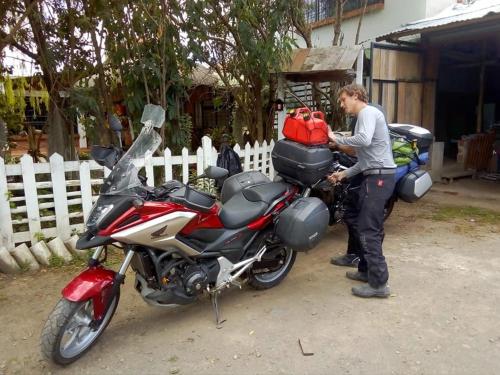 a man is standing next to a motorcycle at Hostal las margaritas in Pasto