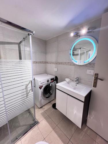 a bathroom with a sink and a washing machine at Byout Beirut G3 in Beirut