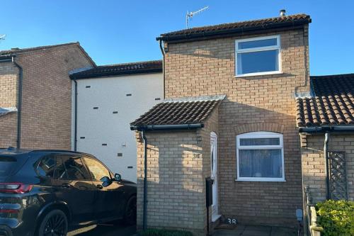 a car parked in front of a brick house at Peak District - 2 Beds - Sleeps 4 - Pet Friendly in Chesterfield