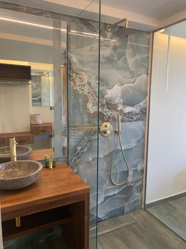 a bathroom with a shower and a sink at Rokamare Beach Resort in Liapades