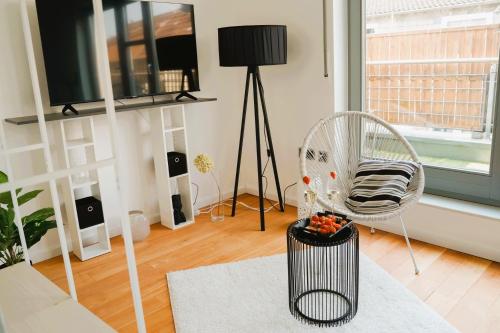 a living room with a chair and a television at Penthouse am Dom- Altstadt in 200 m- 4 Dachterrassen, stilvoll und ruhig-Self Check-6 Personen in Paderborn