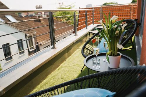 a balcony with a table with a plant on it at Penthouse am Dom- Altstadt in 200 m- 4 Dachterrassen, stilvoll und ruhig-Self Check-6 Personen in Paderborn