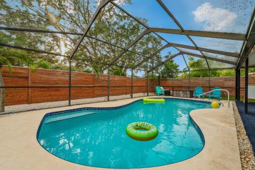 an indoor swimming pool with a pergola over it at Tropical Oasis FL Largo in Largo