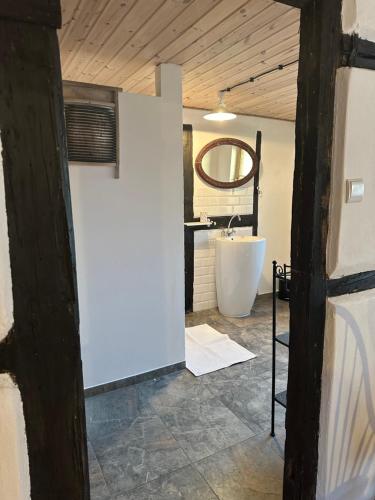 a bathroom with a white tub and a sink at Agroturystyka Zacisze in Maciejowiec