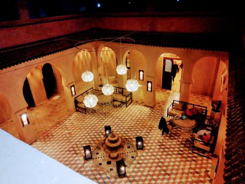 an overhead view of a living room with a tile floor at Riad Dar Ouzine in Merzouga