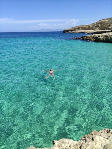 a man swimming in the water in the ocean at Onda Blu in Porto Torres