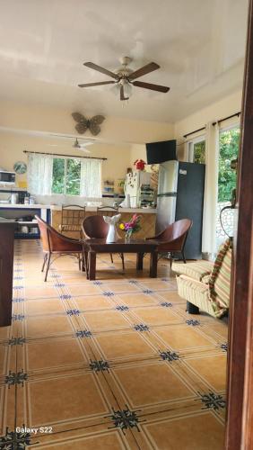 a kitchen and living room with a table and chairs at Yethan house in Uvita