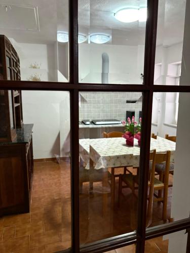 a kitchen and dining room with a table and chairs at L'Autedo in Riccò del Golfo di Spezia