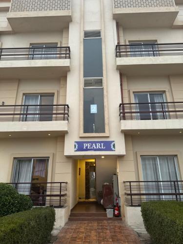 a apartment building with a sign that reads parallel at Garnet suites at omaxe enternity in Chhatikara