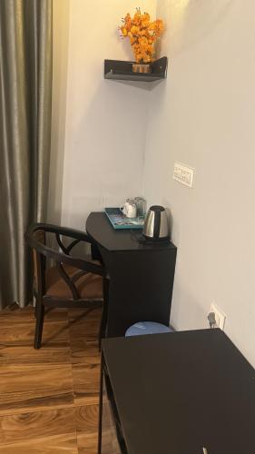 a desk in a room with a phone on it at Garnet suites at omaxe enternity in Chhatikara