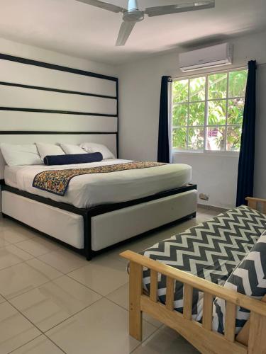a bedroom with a large bed and a window at VILLAS SONJASAA LOFt in Baní