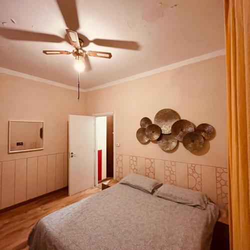 a bedroom with a bed and a ceiling fan at La Caravella apartament in Rapallo