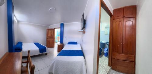 Postel nebo postele na pokoji v ubytování Hostal León Dormido