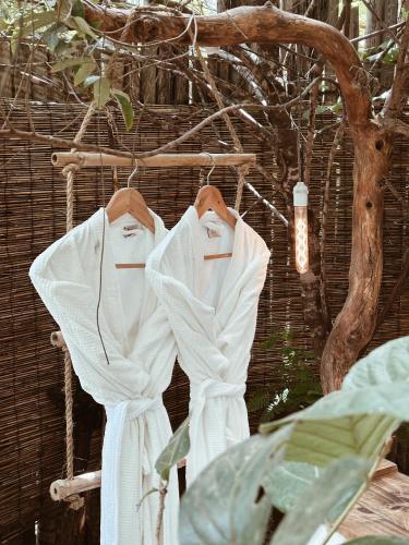 a couple of white shirts hanging on a rack at Vila Abaton in Alto Paraíso de Goiás