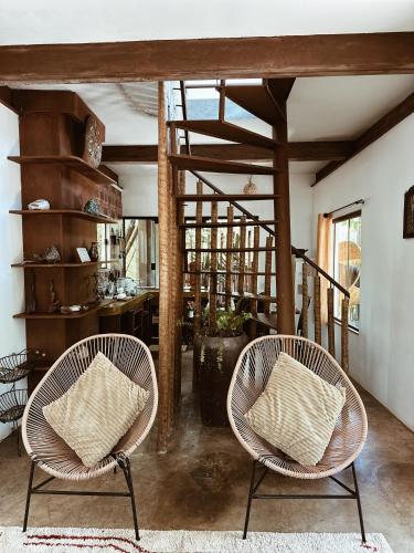 two chairs with pillows sitting in a room at Vila Abaton in Alto Paraíso de Goiás