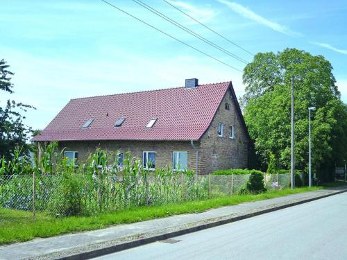 a brick house with a red roof on a street at Ferienwohnung, Parmen bei Feldberg in Parmen