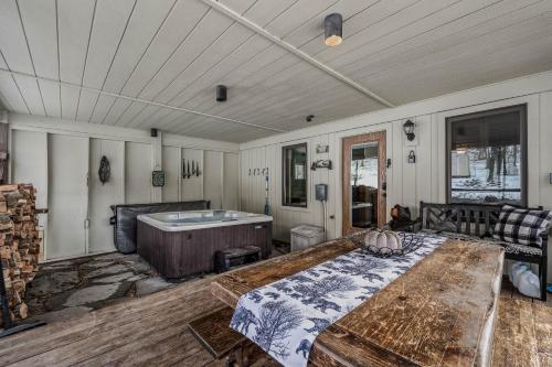 a room with a bed and a bath tub at Sqyrls Nest - Hot Tub, Pet Friendly, Screen Porch, Grill, Wifi, Fire Pit, Deck, View, Family Friendly, Game Room, Shuffle Board, Wood Stove in Berkeley Springs