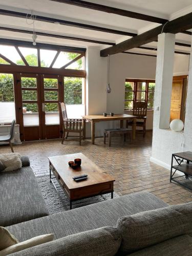 a living room with a couch and a table at Stilvolle 3 Zimmer-Wohnung auf saniertem Resthof in Reher