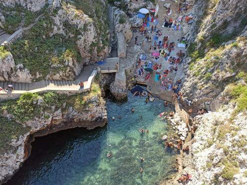 a group of people in the water at a beach at Il Gelso in Lecce