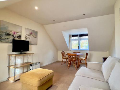 a living room with a couch and a table at Quiet Flat near Biggin Hill Airport Parking 1 Bed in Westerham