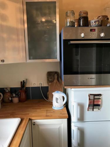 une cuisine avec un comptoir avec un micro-ondes dans l'établissement Cozy Montmartre apartment with views over rooftops, à Paris